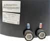 A close-up view of a black water heater with labels and pipe connections. Produktbild-Vorschau