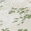 A close-up view of a textured wallpaper with a green abstract pattern. Produktbild-Vorschau