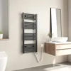 A modern bathroom with a heated towel rack, vanity, and sink. Voir les images du produit