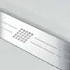 A close-up view of a modern shower drain with a textured white surround. Produktbild-Vorschau