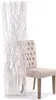 A white decorative screen made of branches is placed next to a beige tufted chair. Náhľad obrázku produktu