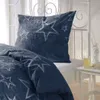 A close-up view of a blue duvet cover and pillow with a white star pattern, placed on a white bed frame. Produktbild-Vorschau