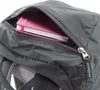 A close-up view of a gray backpack with a pink notebook peeking out of an open zipper pocket. Produktbild-Vorschau