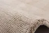 A close-up shot of a textured rug with a beige and light beige color scheme. Produktbild-Vorschau