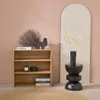 A wooden bookshelf with decorative items and books, placed next to a decorative stand with a vase and dried flowers. Anteprima dell’immagine prodotto