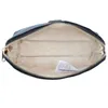 An open black cosmetic bag with a light-colored interior. Produktbild-Vorschau