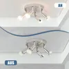 A split image showing a ceiling light fixture with four adjustable spotlights. The top half shows the light emitting a warm white light, labeled 'AN'. The bottom half shows the light emitting a cooler white and colored light, labeled 'AUS'. Produktbild-Vorschau