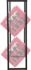 A black metal shelving unit holding two red crates filled with bottles. Produktbild-Vorschau