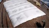 A white duvet is laid out on the wooden deck of a boat. Produktbild-Vorschau