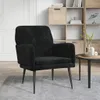 A black velvet armchair sits on a grey rug in a room with a wooden bookshelf in the background. Produktbild-Vorschau