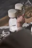 A person is using a water carbonator to make sparkling water. Produktbild-Vorschau