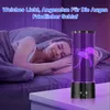 A woman sleeping in bed next to a jellyfish lamp. Produktbild-Vorschau