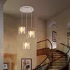 A modern staircase with a chandelier hanging above. Produktbild-Vorschau