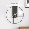 A minimalist wall clock is mounted on a white wall. Produktbild-Vorschau