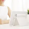 A person is using a white tablet on a desk. Náhľad obrázku produktu