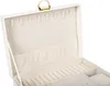 An open white jewelry box with a beige interior, showing compartments for jewelry. Podgląd zdjęcia produktu
