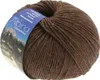 A ball of brown yarn with a label showing a mountain landscape. Produktbild-Vorschau