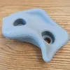 A close-up of a gray climbing hold with two holes, resting on a wooden surface. Voir les images du produit