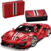 A red toy sports car with racing stripes, along with its packaging, displayed on a white background. Produktbild-Vorschau