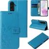 Collage of images showing a blue flip phone case with floral and butterfly embossing from different angles. Produktbild-Vorschau