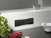A close-up shot of a black double electrical outlet installed on a white kitchen backsplash, with fresh basil and red peppers in the foreground. Produktbild-Vorschau