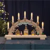 A wooden Christmas arch with illuminated houses and candle-like lights. Podgląd zdjęcia produktu
