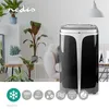 A modern living room with plants and a black and silver air conditioner. Produktbild-Vorschau