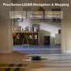 A robot vacuum cleaner is shown on a floor in a room with furniture and artwork. Text overlays describe its features. Produktbild-Vorschau
