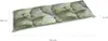 A long, rectangular cushion with a palm leaf pattern, shown from a slightly elevated diagonal angle. Dimensions are indicated with text labels. Produktbild-Vorschau