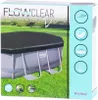 The image shows the packaging of an oval pool cover, with a picture of the pool cover on a grassy lawn. Podgląd zdjęcia produktu