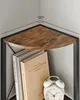 A close-up view of a corner shelf with books and an alarm clock. Náhled obrázku produktu