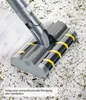 A close-up shot of a vacuum cleaner head cleaning a floor with debris. Produktbild-Vorschau