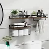 A bathroom shelf unit with toiletries, towels, and toilet paper. Produktbild-Vorschau