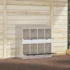 A white chicken nesting box with 8 compartments is shown against a wooden wall. Voir les images du produit