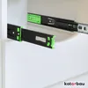 Close-up of black drawer slides with green accents, mounted inside a white cabinet. Produktbild-Vorschau