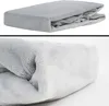 A folded grey blanket is shown in two close-up views against a white background. Produktbild-Vorschau