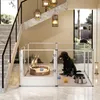 A black Labrador dog and puppies are inside a clear acrylic dog playpen set up in a modern home's entryway, next to a staircase. Anteprima dell’immagine prodotto