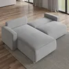 A sectional sofa is shown in a living room setting with wooden floors and a rug. Produktbild-Vorschau