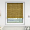 A bamboo roller blind is shown covering a window in a room. Produktbild-Vorschau