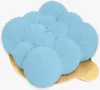 A single, light blue, mousse-like cake with a textured, bubbly surface, presented on a golden cake board. Produktbild-Vorschau