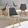 Four gray chairs with wooden legs are arranged on a multi-level white and gray platform. Produktbild-Vorschau
