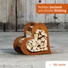 A rusty metal heart-shaped log holder filled with firewood, placed on a concrete surface in front of a wooden wall. Produktbild-Vorschau