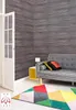 A living room corner with a grey sofa, a colorful geometric rug, and a white door. Anteprima dell’immagine prodotto
