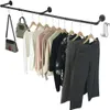 A black industrial-style clothing rack mounted on a white background, displaying various garments and handbags. Produktbild-Vorschau