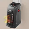 A black portable heater plugged into a wall outlet, with orange and yellow heat waves emanating from it. Anteprima dell’immagine prodotto