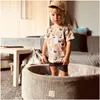 A young child stands in a beige ball pit, wearing a t-shirt with a seagull print and a beige cap. Produktbild-Vorschau