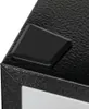 Close-up of a black textured surface with a black diamond-shaped object on top. Produktbild-Vorschau