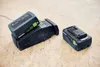 Three battery packs for power tools are arranged on a wooden surface. Anteprima dell’immagine prodotto