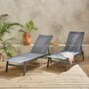 Two gray lounge chairs are set up on a wooden deck next to a concrete wall with plants and a decorative vase. Anteprima dell’immagine prodotto