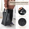 A person is holding a black laundry bag in front of a washing machine. Produktbild-Vorschau